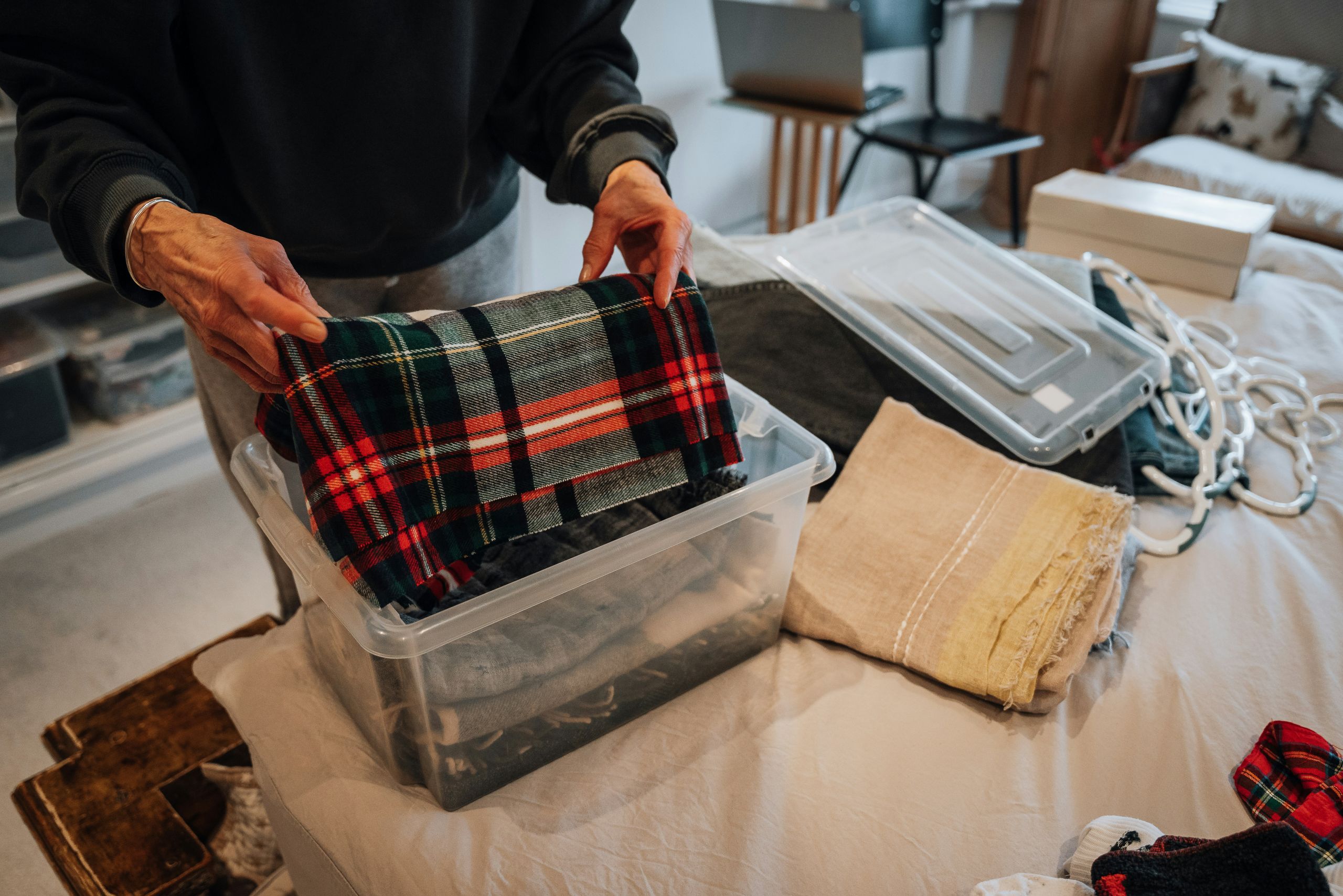 Garment Care Services a person folding clothes the right way, showing how to make clothes last longer